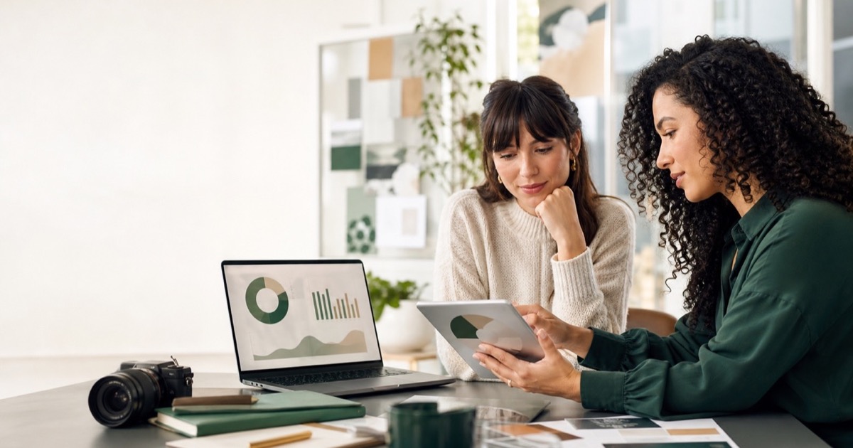 Creator and strategist reviewing verified social performance charts together